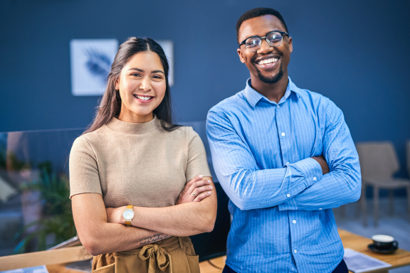 Two colleagues smiling at the camera