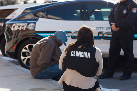 Clinician with their back to the camera speaking to someone as part of the Advocates Community Justice program