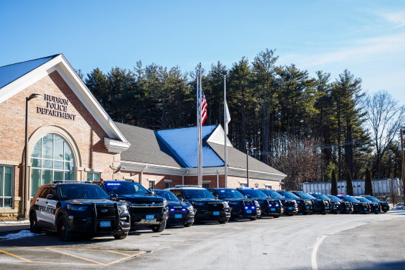 Police cars parked in front of a police station.