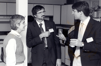 Bill Taylor and Advocates staff talking in kitchen at the opening of the program.