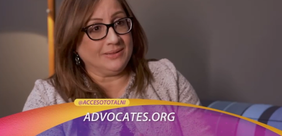 An adult with long straight brown hair and glasses is shown in a screenshot from a TV show